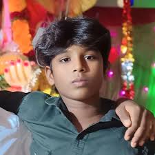 A close-up, high-quality portrait of a stylish Indian young man. He has  well-styled, voluminous dark hair . He is wearing a pastel lavender  crewneck sweater with the name 'Giriraj'embroidered in purple. He