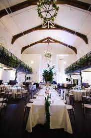 Reception Decor With Greenery Hanging From The Balcony Chandelier Garlands Garland Lined Cincinnati Wedding Venues Ohio Wedding Venues Wedding Table Flowers