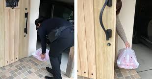 Delivery man holding cardboard boxes in medical rubber gloves and mask. Domino S Pizza Hut Introduce Zero Contact Delivery Service Amid Virus Fears Japan Today