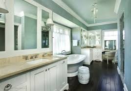To shrink this space you can paint the ceilings two to three shades darker than the walls. Ceiling And Walls The Same Colour With White Trim As Highlights Hardwood Floors In Bathroom Bathroom Freestanding Master Bathroom