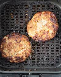 Air fryer frozen hamburgers are even better than grilled hamburgers! Cooked Air Fryer Turkey Burgers In Air Fryer Basket Cooking Turkey Burgers Air Fryer Dinner Recipes Turkey Burgers