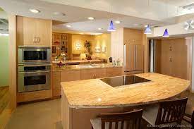 A bright blue kitchen with a bright mosaic tile backsplash and bold touches of yellow here and there is super cool. Yellow Granite Kitchen Counters Modern Kitchen Colours Light Wood Kitchens Wood Kitchen Cabinets