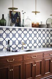 Blue Patterned Tile Backsplash With Single Marble Open Shelf Traditional Kitchen Cabinets Floating Shelves Kitchen Kitchen Cabinet Styles