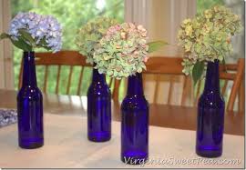 Black And Blue Beer Beer Bottle Centerpiece Yes I Did Sweet Pea Beer Bottle Centerpieces Beer Bottle Wedding Decor Wine Bottle Flowers