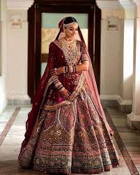 Is The Traditional Maroon Wedding Lehenga Slowly Making A Way Back Indian Bridal Outfits Indian Bridal Lehenga Indian Bridal Dress