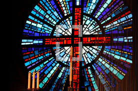 Round stained glass window in church. Circular Stained Glass Window Of The Cross In A Photo Lightstock