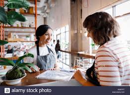 hostess talking looking at seating chart stock photo