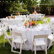 Crisp White Table Linens And Wooden Folding Chairs Were A Neutral Backdrop Against The Lu Wedding Reception Table Decorations Table Decorations Reception Table