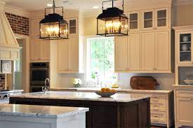 Cabinets painted a pale sage green add a casual, calming feel to this kitchen. Iron Kitchen Island Lanterns Traditional Kitchen Luxe Living Interiors