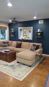 Blue painted living room idea with coastal art & floating coral shelves from wisteria, featured here. Blue Paint Color Seaworthy By Sherwin Williams Perfect For Living Room Accent Wall Accent Walls In Living Room Living Room Wall Color Blue Living Room