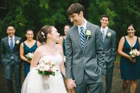 Stylish navy bridesmaids, your shoes and his tie; Bride And Groom In Front Of The Wedding Party