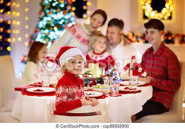 Christmas family dinner table concept. Family With Kids Having Christmas Dinner At Tree Family With Children Eating Turkey Christmas Dinner At Fireplace And Canstock