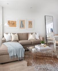 Neutral Living Space Featuring L Shape Sectional Couch And Statement Animal Print Rug Beige Couch Living Room Beige Living Rooms Couches Living Room Apartment