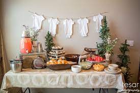 Decor Simple And Gender Neutral The Onesies Are A Good Backdrop And Don T Indicate Boy Or Girl Baby Shower Fall Baby Shower Brunch Adventure Baby Shower
