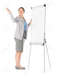 Business Trainer Giving Presentation On Flip Chart Board Against