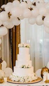 White Wedding Cake Table With Balloon Arch Backdrop On Top Of Gold Placema Vintage Wedding Cake Table Wedding Cake Table Decorations Wedding Cake Display Table