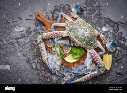 Fresh Raw Crab With Ingredients Lemon Rosemary And Lettuce For Making  Cooked Food On Ice At Market / Seafood Frozen , Blue Swimming Crab Stock  Photo - Alamy