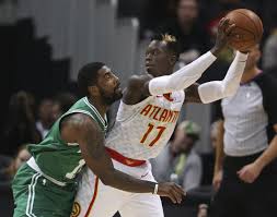 Atlanta Hawks Guard Dennis Schroder 17 Looks To Pass As Boston Celtics Guard Kyrie Irving 11 Defends During The First Hal Kyrie Irving Kyrie Boston Celtics