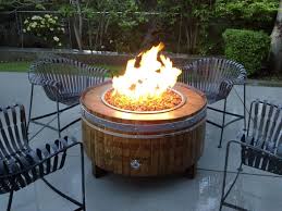 This upcycled wine barrel can be turned not only into a fire pit but a table as well. How To Repurpose Wine Barrels Into Amazing Creations For Your Yard Wine Barrel Fire Pit Outdoor Propane Fire Pit Fire Pit Decor