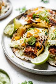 Trager fish tacos are one of our favorites in our home! Grilled Cod Fish Tacos Mango Ginger Slaw Avocado Crema Pwwb