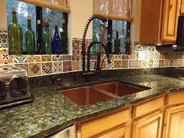 The tiles really work in this modern kitchen. Mexican Tile Backsplash Copper Sink Verde Peacock Granite Counter Talavera Tile Bac Mexican Tile Kitchen Backsplash Mexican Tile Kitchen Trendy Kitchen Tile