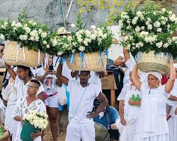 Image of Throwing white flowers into the ocean for New Year's