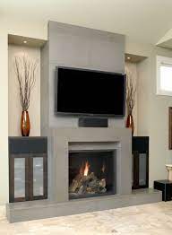 In california mantel, fireplaces are in different forms such as modern, traditional, gas inserts, electric, outdoor living and wood burning. Solus Block Concrete Fireplace Surround With Wall Tiles And Hearth In Shiitake Contemporary Fireplace Designs Contemporary Fireplace Home Fireplace