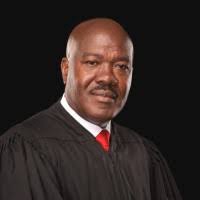 Charles E. Woode, LL.B., J.D., LL.M., FCIArb