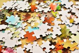 A pile of puzzle pieces sitting on top of a table. Pieces… — PICRYL -  Public Domain Media Search Engine