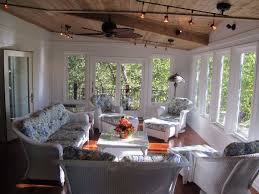 Enclosed porch with blue textiles and white curtains. 7 Addition Ideas Four Seasons Room Sunroom Addition Room Additions
