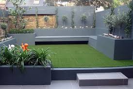 Raised Beds Grey Colour Scheme Artificial Grass Agapanthus Olives Porcelain Grey Tiles Yellow Stock Brick Walls Grey Floating Bench Lighting Gardens Londo