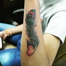 I like the lover heart in the middle with it's beautiful colors. Top 30 Peacock Feather Tattoos Best Peacock Feather Tattoo Designs