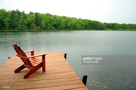 Dock With Adirondack Chair By The Side Of A Lake Sun Lakes Lake Cottage Adirondack Chair