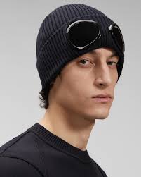 Crafted in a ribbed knit pattern, this piece features a turned up hem and is then finished with a pair of lenses embedded into. Cotton Goggle Beanie C P Company Online Store