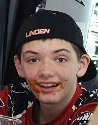 Yirdaw Rivera of Sayville carries the Section XI flag into the MVP Arena.  Behind him is Joe LaCorte of John Glenn.