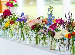 Table Runner Of Vintage Inspired Bottles And Wild Flower Blooms Wedding Flowers Table Floral Decorations Table Flowers
