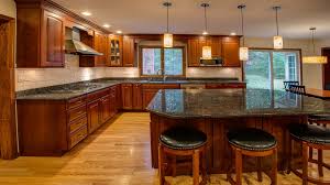 Single wall kitchen with red cabinets and black island. Natural Red Oak Vinyl Flooring Planks Ferma Flooring