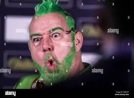 Peter Wright pulls a funny face during an interview during day one of the  William Hill World Darts Championship at Alexandra Palace, London Stock  Photo