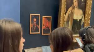 Pranksters hang portraits of Trump and Merz in Louvre next ...