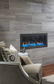 Room with fireplace and wood floors. Love The Floor To Ceiling Tile Surround On This Fireplace In The Bay Area Jolene Model Home Richmond Am Home Fireplace Fireplace Tile Tiled Fireplace Wall