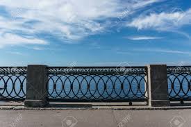An intricate design on a shorter wrought iron fence. Wrought Iron Railings With Concrete Pillars Against The Blue Stock Photo Picture And Royalty Free Image Image 66205875