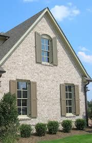 This wall treatment, for case in point, draws shades against the regular rug. The Side Of A Brick Home Can Be Just As Dramatic As The Front Add A Segmental Arch And Brick Sill To The Brick Exterior House House Exterior Shutters Exterior