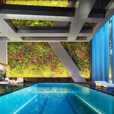 A Lush Tapestry Of Tropical Foliage Rests At The Finish Line Of This 65ft Lap Pool Just One Of Several Breatht In 2020 Museum Of Modern Art Skyscraper Vertical Garden