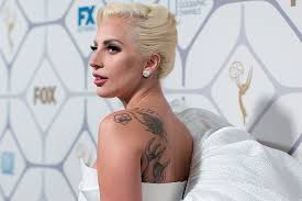 Upper back hope dream and believe breast cancer with colorful wings tattoo photo: Lady Gaga Brands Herself With Survivor Tattoo Page Six