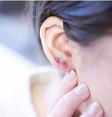 Floral Earring Tattoo On Ear Lobe Ear Lobe Tattoo Tiny Flower Tattoos Tattoos