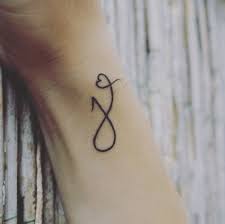 The line work is sharp, fine needlework in black for the major letter. The Letter J Tattoo Designs Letters Font J Tattoo Letter J Tattoo Tattoo Lettering