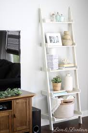 Unfinished floor, boxes and a ladder in the corner. Coastal Inspired Summer Living Room Caitlin Marie Design