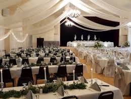 Behind the portraits is a podium with draped ribbons and flowers carved into it. 14 Banquet Halls And Wedding Venues Around Monroe Wisconsin