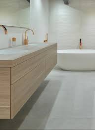 Le fini gris chêne clair donne un effet de bois de grange issu des dernières tendances et le design rectiligne avec les poignées en aluminium lui la collection kanva propose un design minimaliste au fini blanc lustré qui lui permet de s'agencer facilement à la majorité des décors de salle de bain. Salle De Bain Design Blanche Et Doree Meuble Bois Clair Robinetterie Robinet Or Salle De Bain Design Salle De Bains Blanche Et Grise Salle De Bains Gris Clair