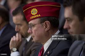 Daniel Dellinger, national commander of the American Legion, listens...  News Photo
